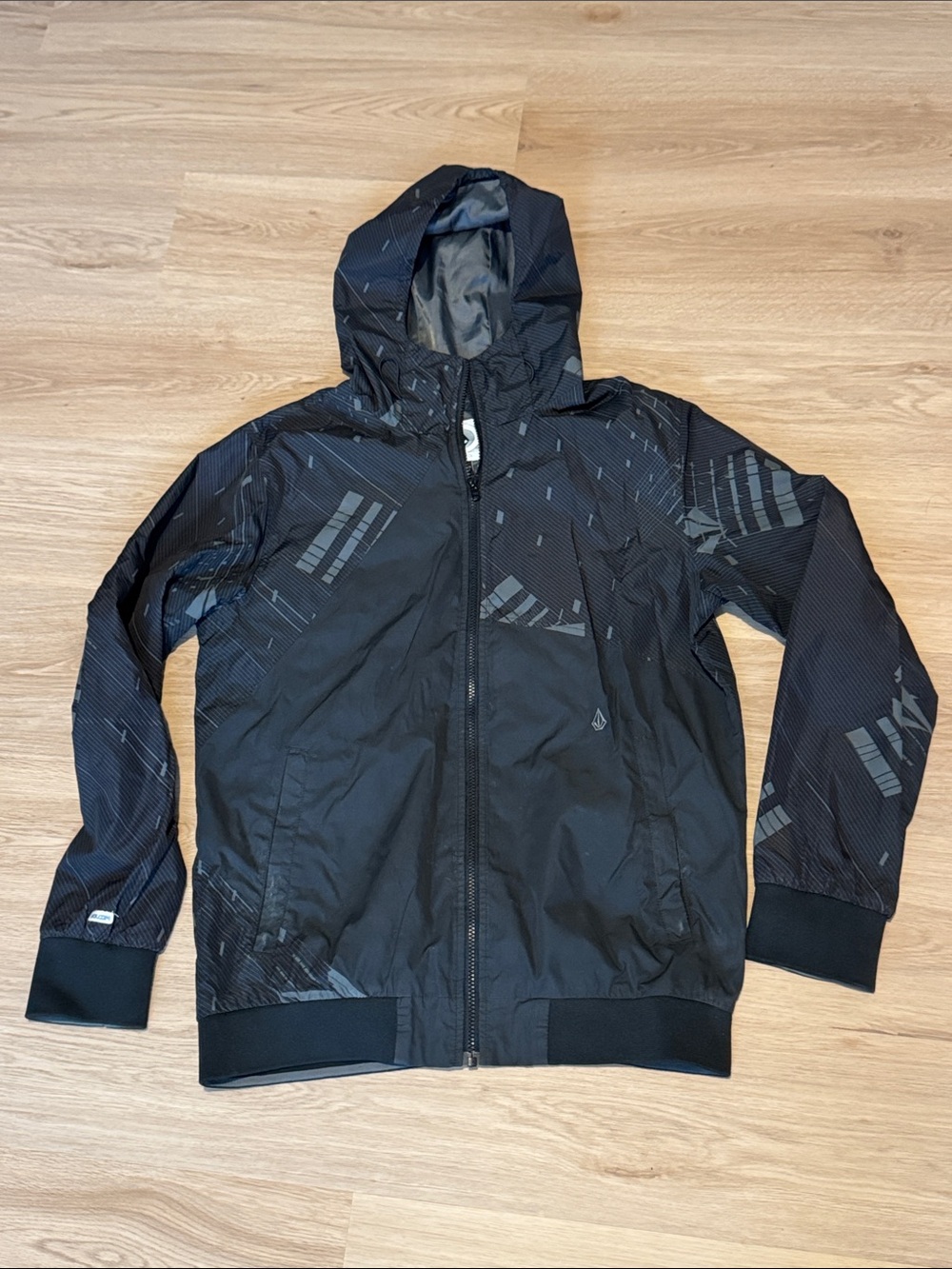 Volcom Men's Black Hooded Windbreaker with Subtle Geometric Print